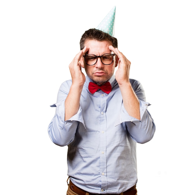 Man wearing a red bow tie and party hat. Looking in a deep think