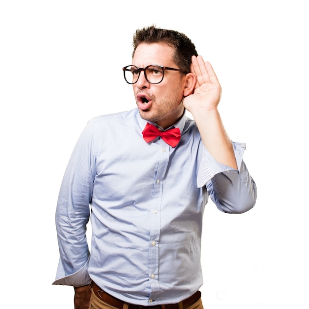 Man wearing a red bow tie. Paying attention to a noise.