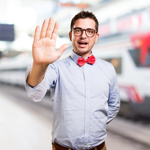 Man wearing a red bow tie. Showing his palm.