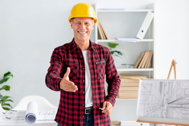 Man wearing safety helmet and giving a hand shake