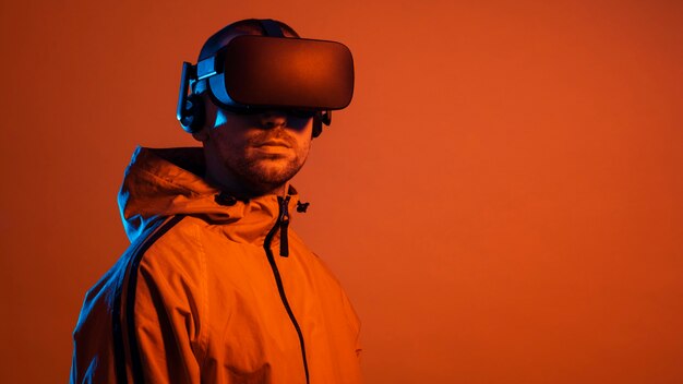 Man wearing virtual reality gadget  with orange light