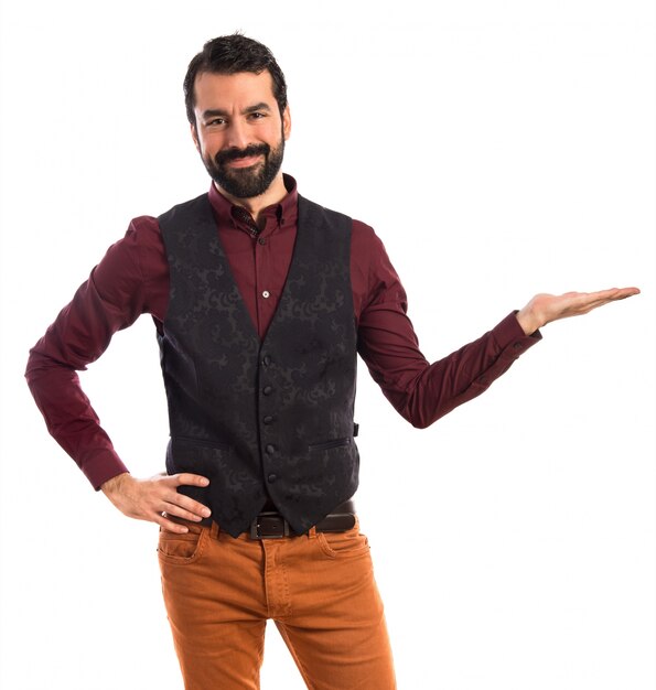 Man wearing waistcoat presenting something