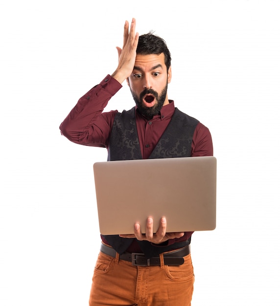 Man wearing waistcoat with laptop