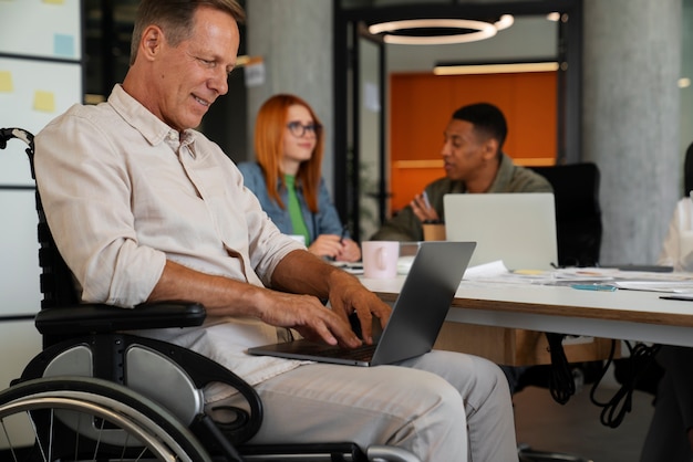 Man in a wheelchair having an inclusive office job