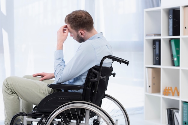 Man in wheelchair thinking