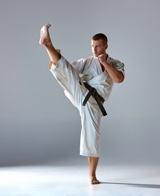 Man in white kimono training karate