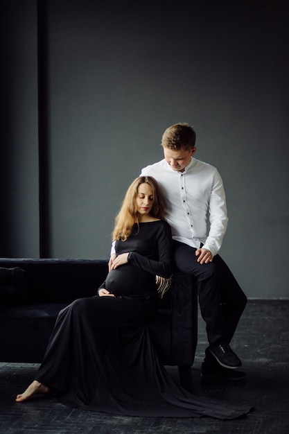 Man in white shirt and female in black dress Pregnancy photo