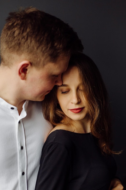 Man in white shirt and female in black dress Pregnancy photo