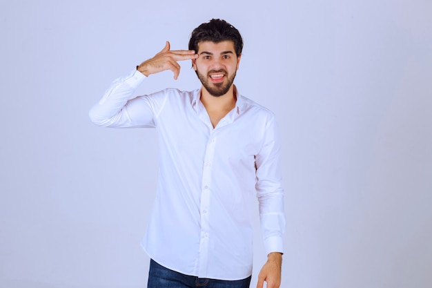 Man in white shirt looking and thinking.