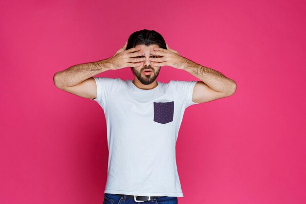 Free photo man in white shirt looks exhausted and sleepy.