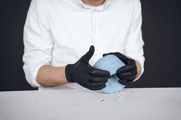 Free Photo man in a white shirt works with a cement