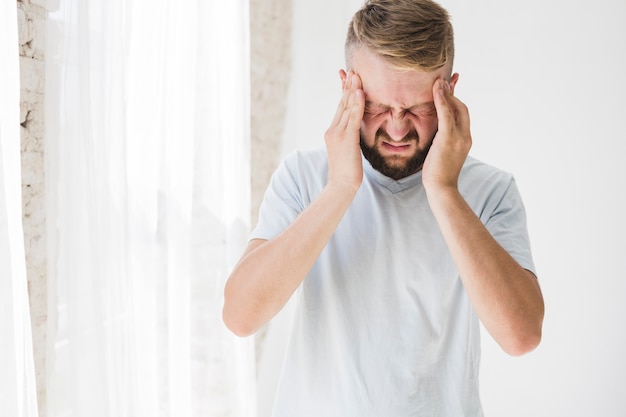 Man in white suffering from pain