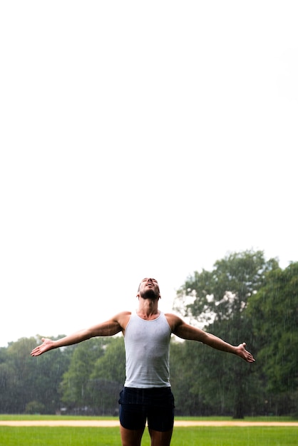 Man with arms wide open and copy space