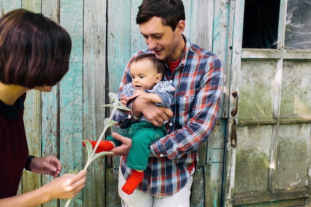 Man with baby and wife outside