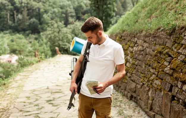 Free photo man with backpack traveling alone at ruins