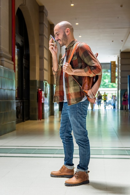 Man with backpack using mobile