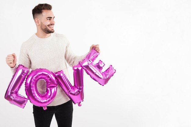 Free Photo man with balloon love writing looking away