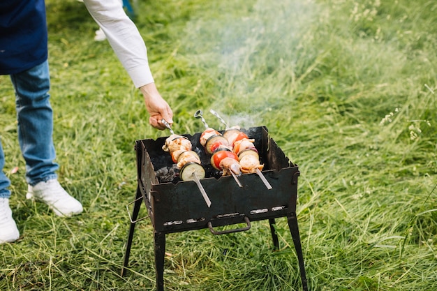 Free Photo man with a barbecue in nature