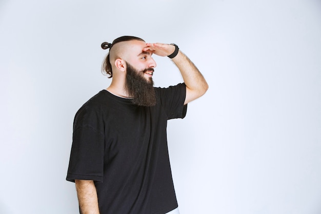 Free photo man with beard greeting his friends.