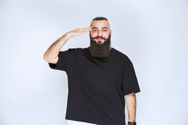 Man with beard greeting his friends. 