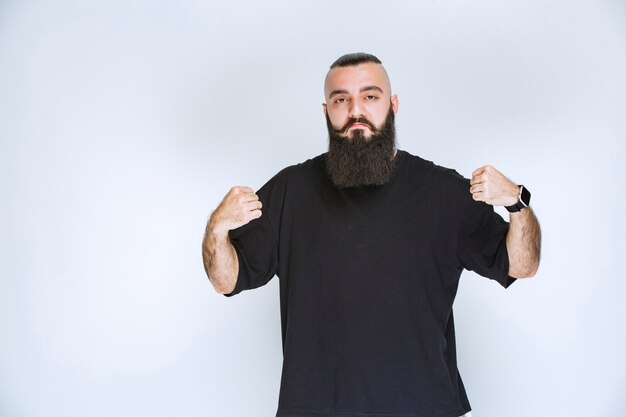 Man with beard showing his fist and looking powerful. 