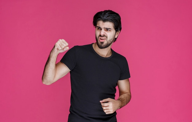 Man with beard showing his fists and feeling powerful