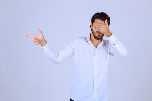 Man with beard showing thumb up sign.