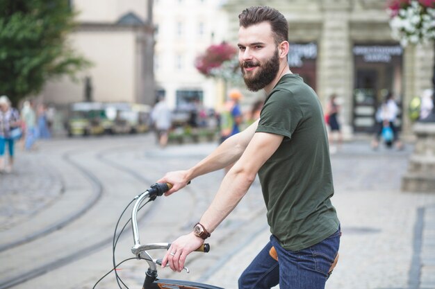 Man with bicycle in city