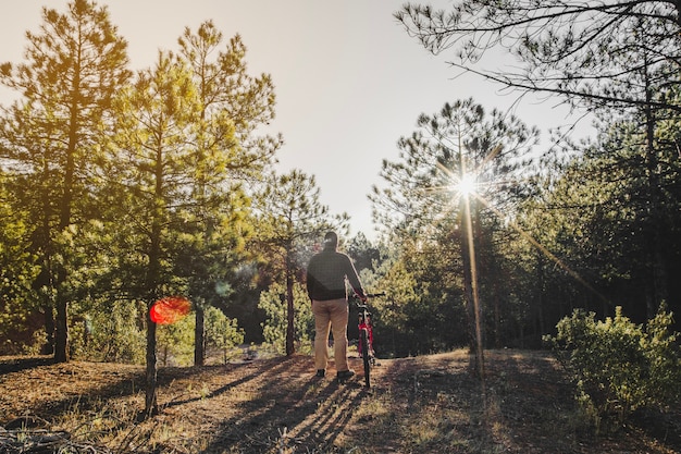 Free photo man with bike in countryside