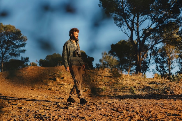 Man with binoculars walking in nature