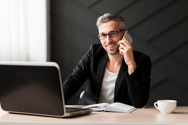 Man with black jacket talking on the phone