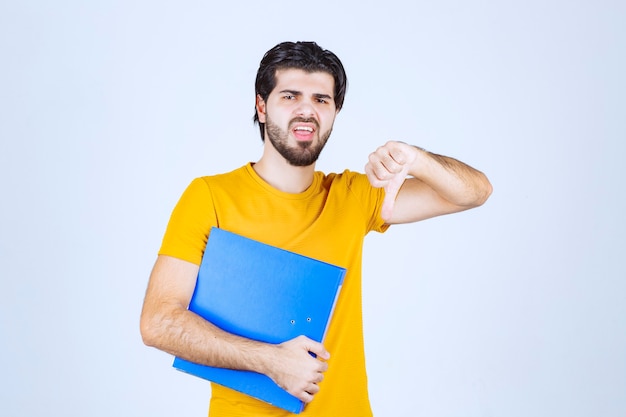 Man with blue folder doing thumb down.