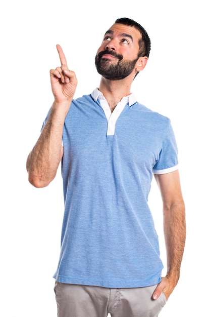 Man with blue shirt pointing up