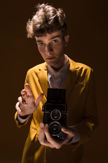 Man with a camcorder in a yellow scene