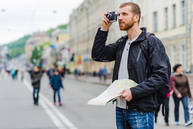 Free photo man with camera and map