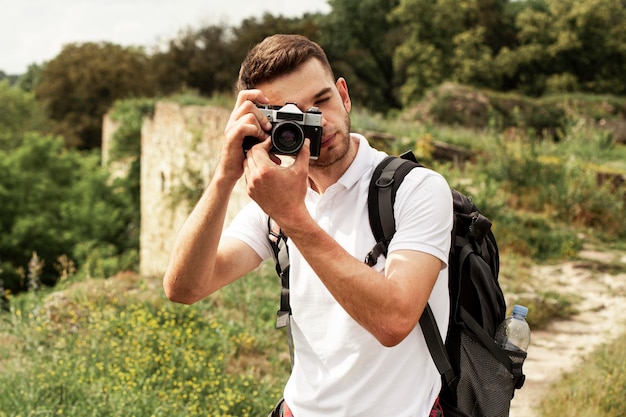 Free photo man with camera taking photos