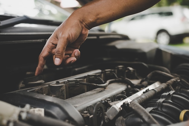 Free photo man with checking car engine.