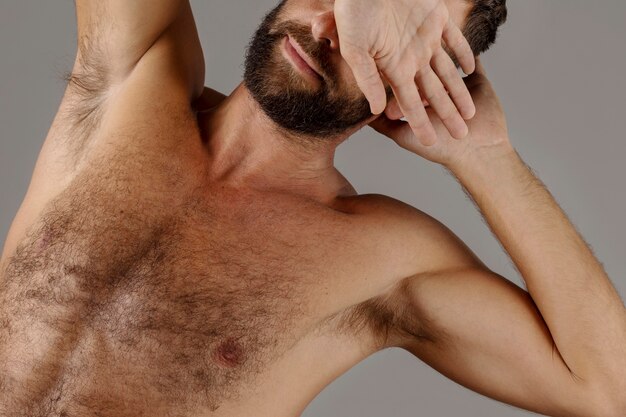 Man with chest hair posing in studio front view