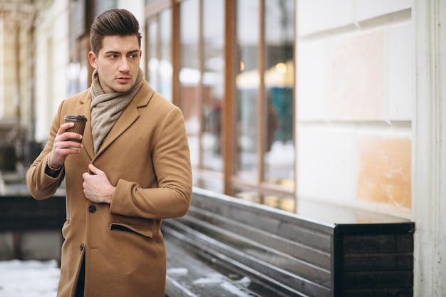 Free photo man with coffee outside in winter