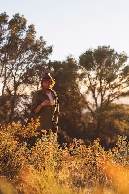 Man with cup in nature