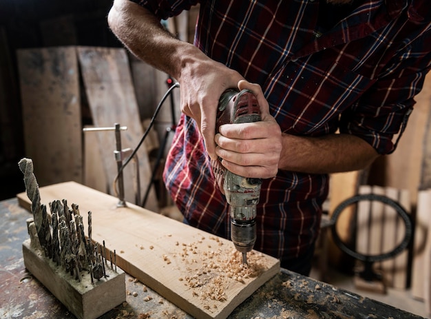 Man with drill working with wood