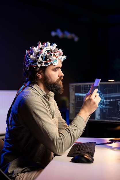 Free photo man with eeg headset putting disk in computer to start consciousness upload