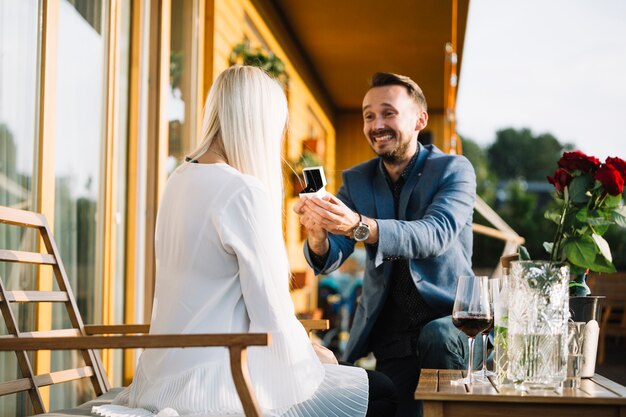 Man with engagement ring making proposal of marriage to woman