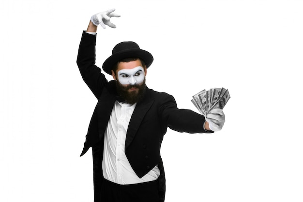 Man with a face mime dancing with money isolated on a white  concept concept love of money, happiness from money luck