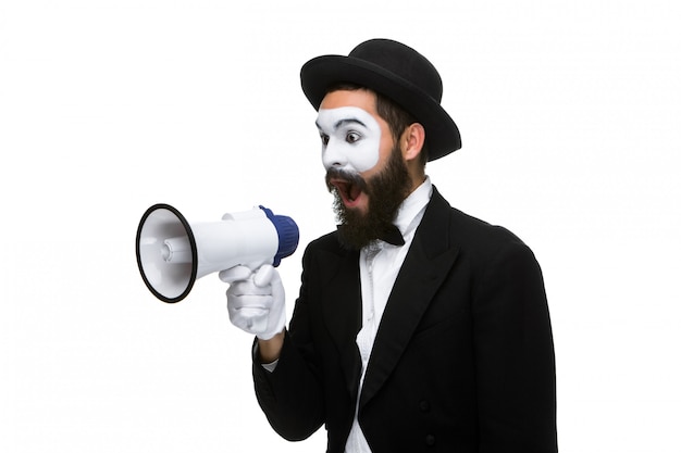 Man with a face mime screaming into megaphone