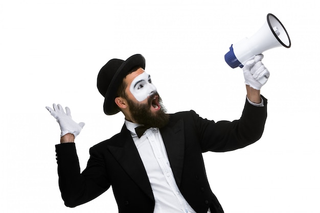 Man with a face mime screaming into megaphone