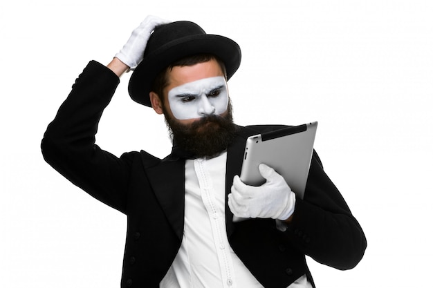 Man with a face mime working on laptop