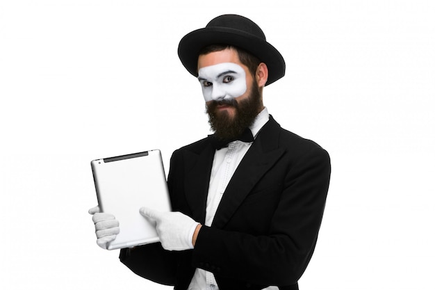 Man with a face mime working on laptop