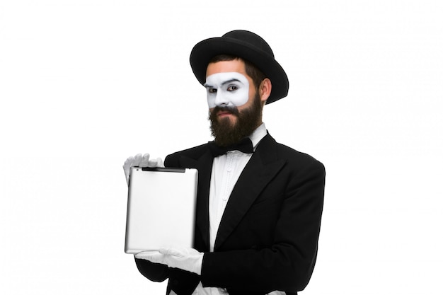 Man with a face mime working on laptop