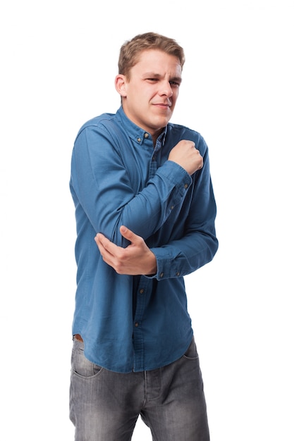 Man with face of pain touching his elbow